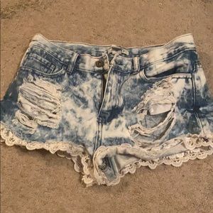 blue and white tie-dye ripped jean shorts